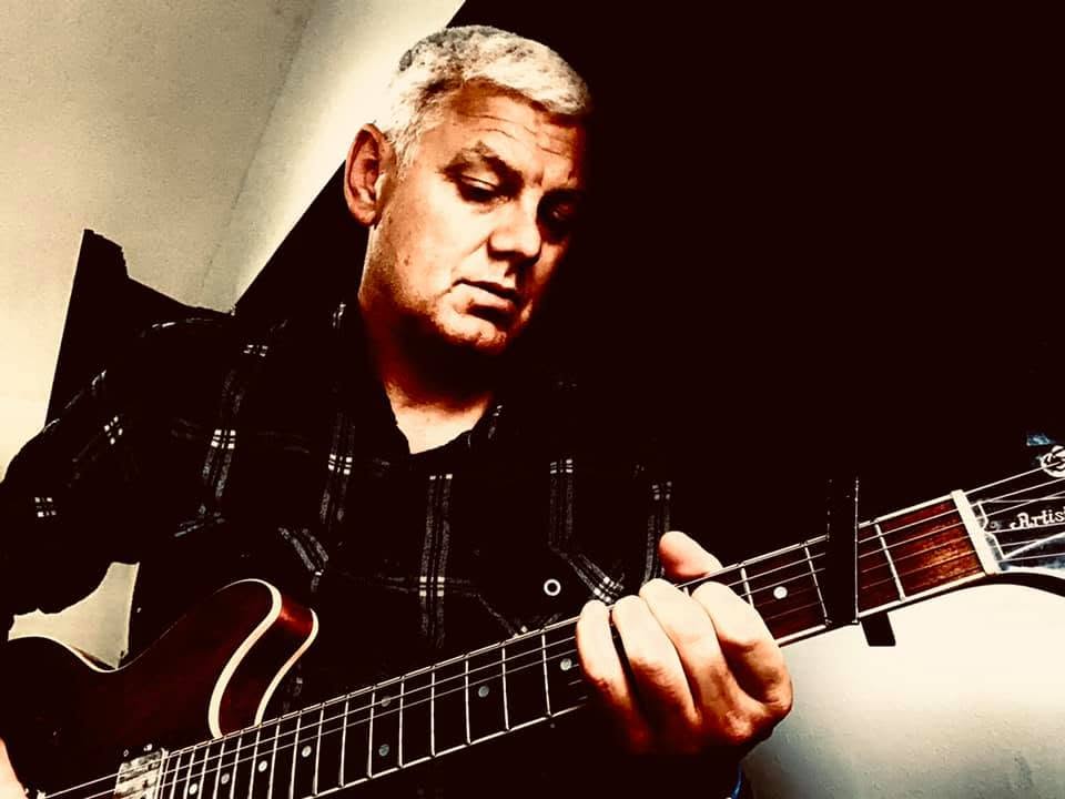 Singer-songwriter Ryan Edwards holding an electric guitar